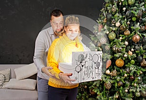 Man giving a Christmas present to his girlfriend. Opening gift box at christmas time. Christmas wonder concept