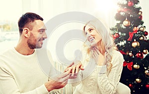 Man giving engagement ring to woman for christmas