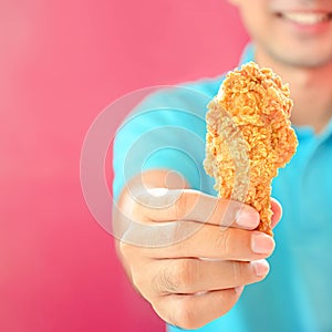 A man giving fried chicken leg or drumstick