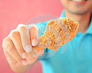 A man giving fried chicken leg or drumstick