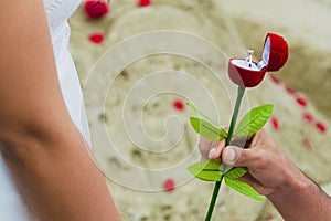 Man giving gift box with engagement ring to woman