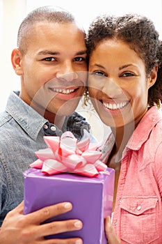 Man giving gift to woman