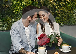 Man Giving Girlfriend Roses Confratulating On Women`s Day In Cafe