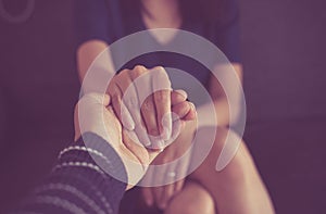 Man giving hand to depressed woman,Psychiatrist holding hands patient,Mental health care concept