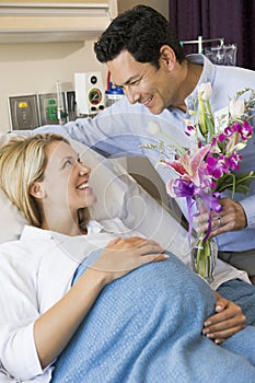 Man Giving His Pregnant Wife Flowers