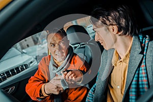 Man giving his son the car keys.