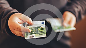 Man giving money cash. Male hands holding hundred euro banknote bill. Credit