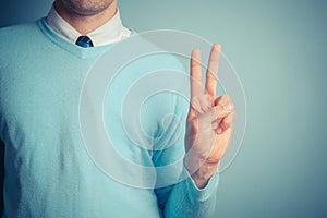 Man giving peace sign