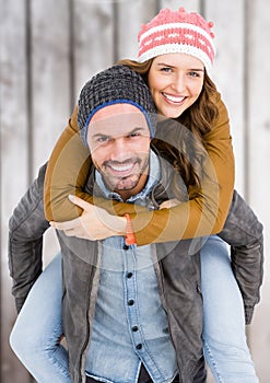 Man giving piggy back to woman