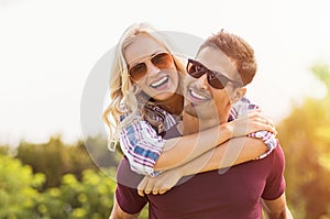 Man giving piggyback ride to woman