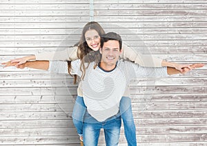 Man giving a piggyback ride to woman