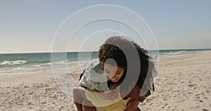 Man giving piggyback ride to woman on the beach 4k