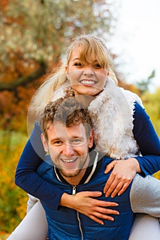 Man giving piggyback ride to woman in park