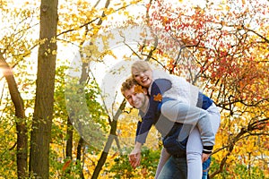 Man giving piggyback ride to woman in park