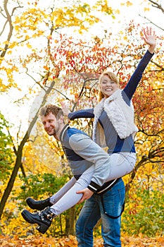 Man giving piggyback ride to woman in park