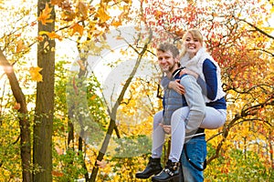 Man giving piggyback ride to woman in park