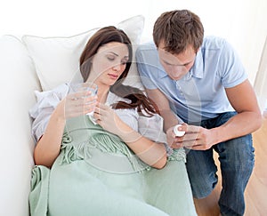 Man giving pills to his sick wife