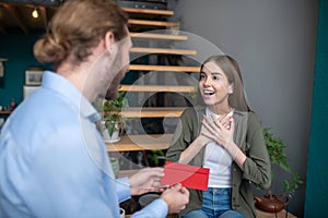 Man giving a red envelope to the admired woman