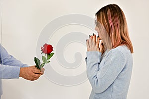 Man giving a red rose and surprised woman. Valentine card concept.