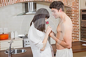 Man giving red rose to woman