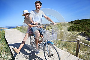 Man giving ride to his girlfriend on bicycle