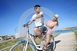 Man giving ride to his girlfriend on bicycle