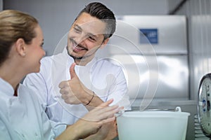 man giving thumb up to female ice cream worker