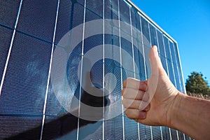 A man giving thumbs up for alternative energy. Concept of clean solar energy. Like to alternative energy sun energy power