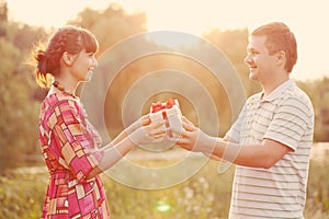 Man giving to his woman a gift box. Retro style.