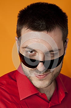 Man giving a wink over sunglasses