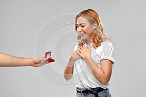 Man giving woman engagement ring on valentines day