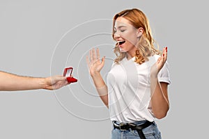 Man giving woman engagement ring on valentines day