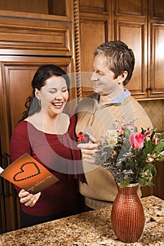 Man giving woman gifts.