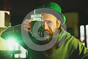 Man with glass of beer in pub. St. Patrick`s Day celebration