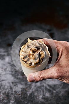 Man with a glass of dalgona coffee photo