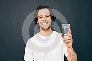 man glass of water in his hands emotions posing  background