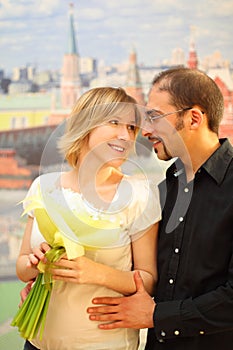 Man in glasses embracing beauty blond girl