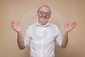 Man in glasses having confused look, shrugging shoulders