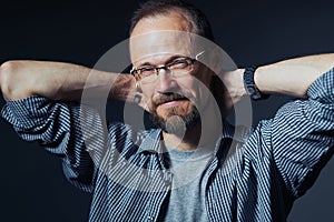 Man in glasses looking at camera with mistrust expression