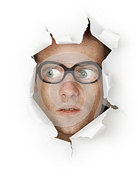 Man in glasses looking out of hole