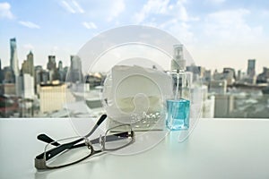 Man glasses on the office desk with alcohol bottle backdrop