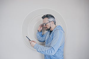 man with glasses with presbyopia looking at the phone