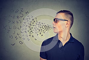 Man in glasses talking with alphabet letters coming out of his mouth. Communication concept