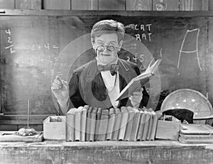 Man with glasses teaching in a classroom