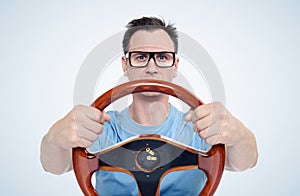 Man in glasses with wooden steering wheel, car driver concept