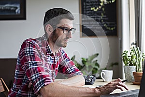 Man with glasses working from home