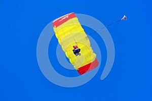 Man gliding down on a parachute