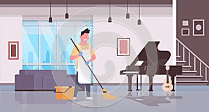 Man in gloves and apron washing floor guy using mop doing housework cleaning concept modern house living room interior