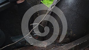 a man in gloves saws metal with a cutting disc. angle grinder. working with metal. fiery bright splashes from the disk