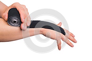 Man glues black sports tape on hand from injury isolated on white